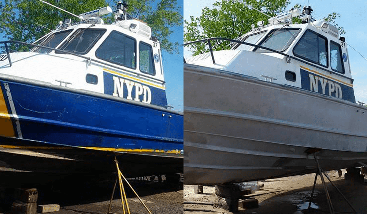 A blue and white boat is parked next to a white boat